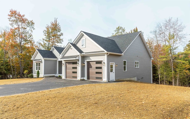 view of front of property featuring a garage and a front yard