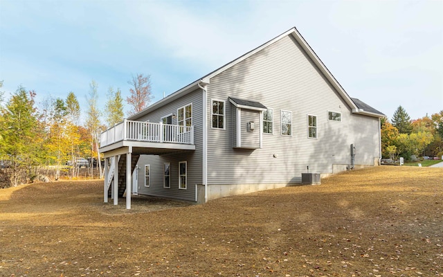 rear view of house featuring central AC unit