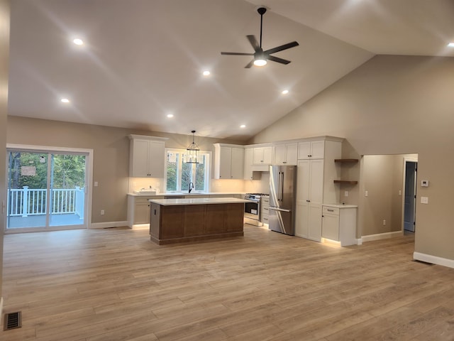 kitchen with a kitchen island, appliances with stainless steel finishes, pendant lighting, white cabinetry, and ceiling fan