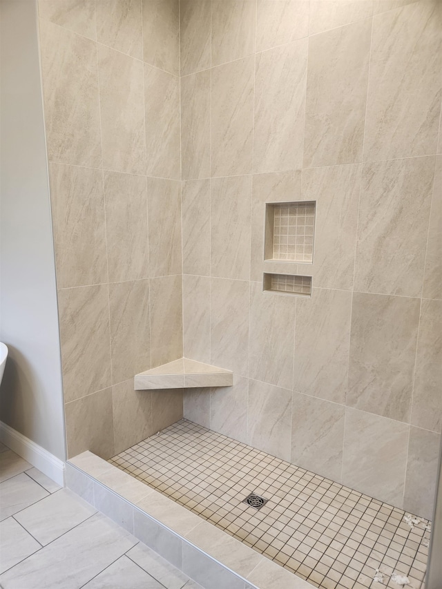 bathroom with tiled shower