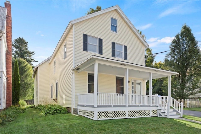 view of front of property with a porch and a front yard