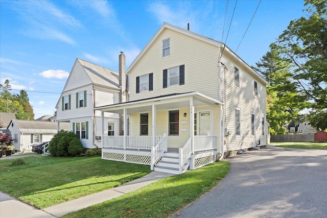 view of front of property with a porch and a front yard