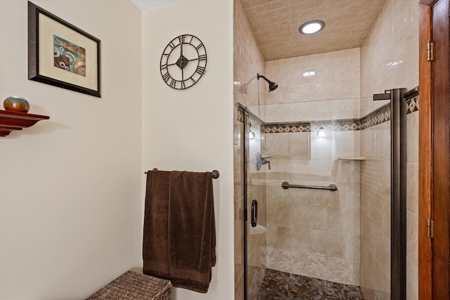 bathroom featuring a shower with shower door