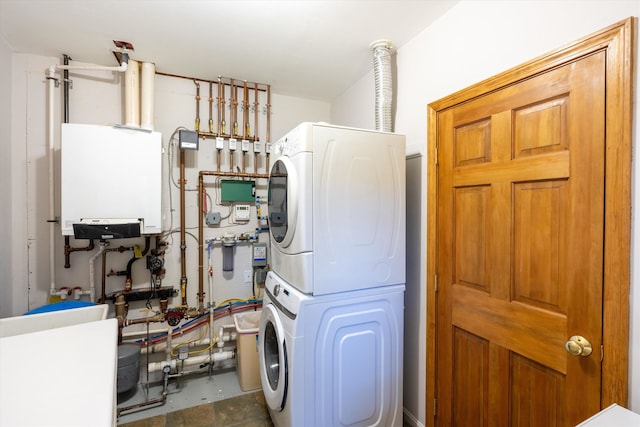 utilities featuring stacked washer and dryer, tankless water heater, and sink