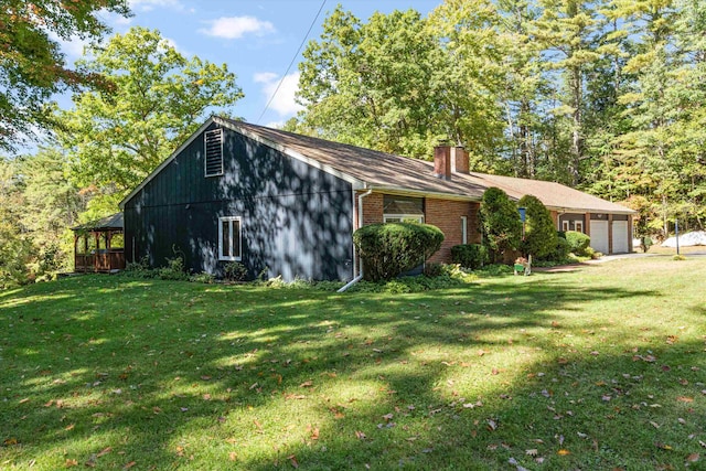 view of home's exterior with a lawn and a garage