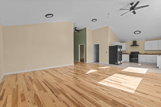 unfurnished living room with ceiling fan, light hardwood / wood-style flooring, and high vaulted ceiling