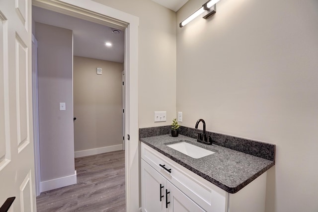 bathroom with vanity and hardwood / wood-style flooring