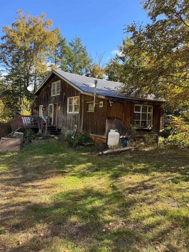 rear view of house with a yard