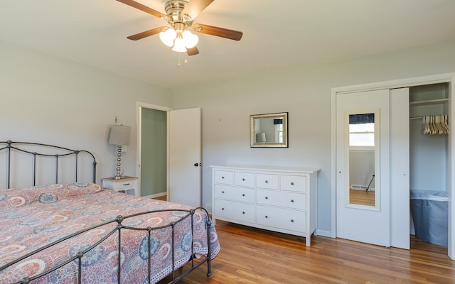 bedroom with ceiling fan, light hardwood / wood-style flooring, and a closet