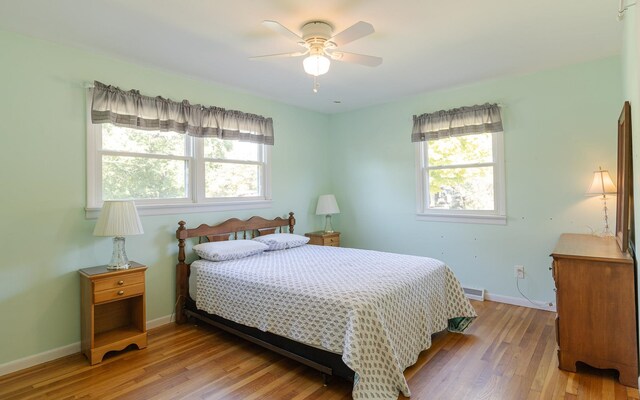 bedroom with light wood-type flooring and ceiling fan