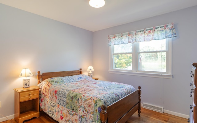 bedroom with wood-type flooring