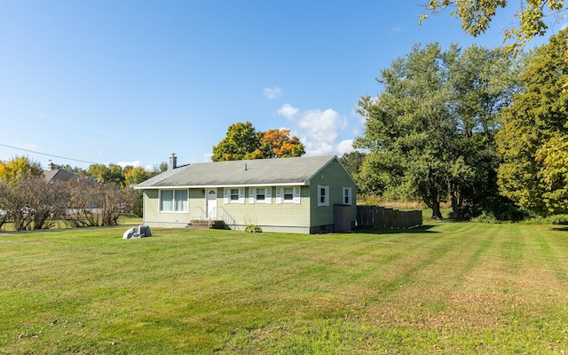 rear view of property with a yard