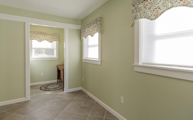 clothes washing area featuring plenty of natural light and tile patterned floors