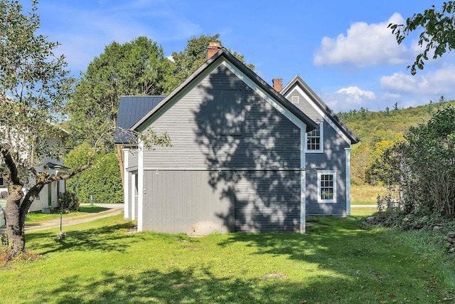 view of home's exterior with a yard