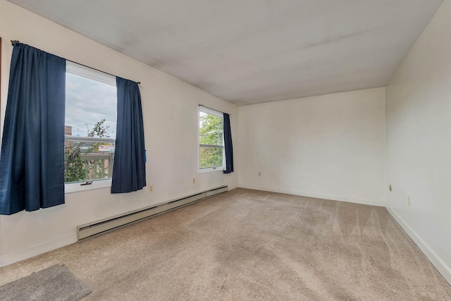 unfurnished room featuring a baseboard radiator, carpet, and baseboards