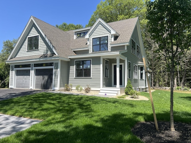 330 High St, Hampton, NH 03842 - view of front of home with asphalt driveway, a shingled roof, a front yard, and an attached garage