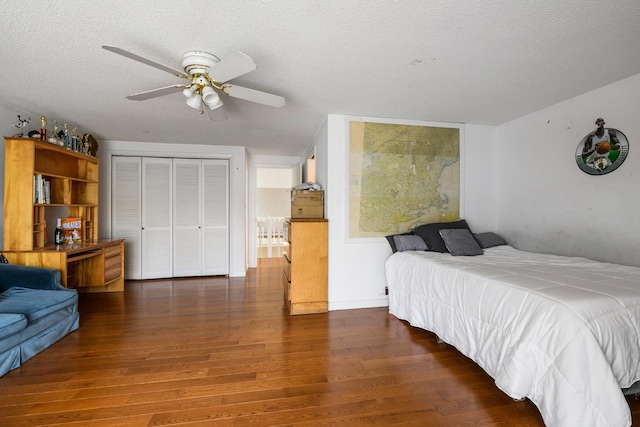 bedroom with a closet, ceiling fan, dark hardwood / wood-style floors, and a textured ceiling