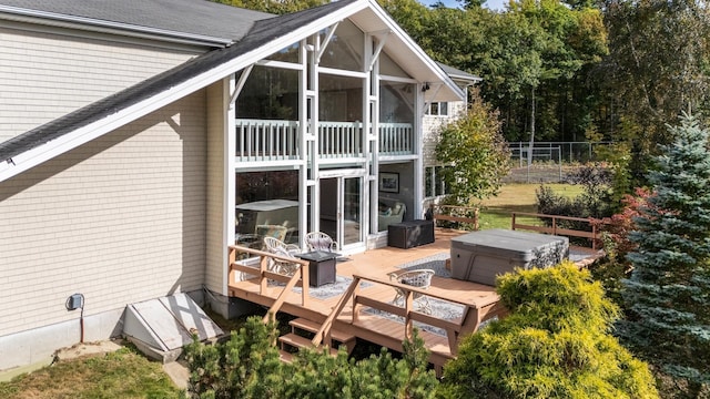 back of property featuring a deck and a sunroom