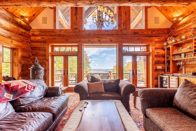 living room with plenty of natural light, french doors, and high vaulted ceiling