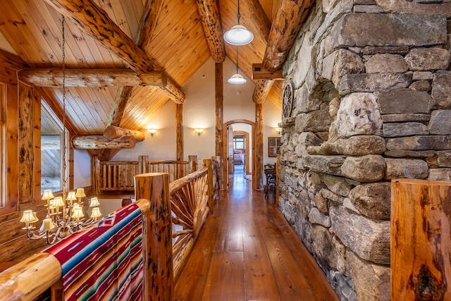 corridor with beamed ceiling, wood ceiling, dark wood-type flooring, and high vaulted ceiling