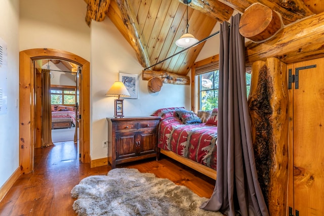 bedroom with vaulted ceiling with beams, wooden ceiling, and dark hardwood / wood-style flooring