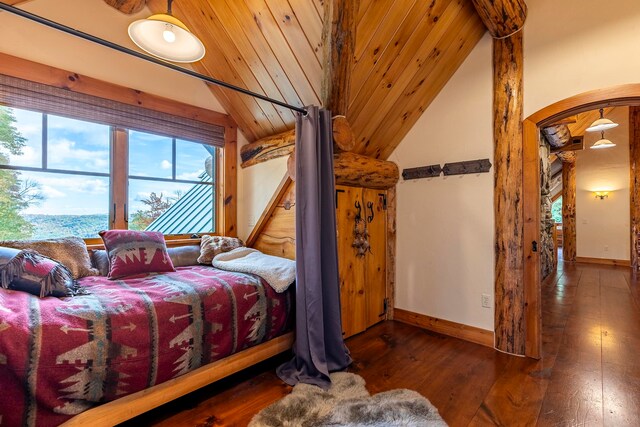 bedroom featuring lofted ceiling, wooden ceiling, and dark wood-type flooring