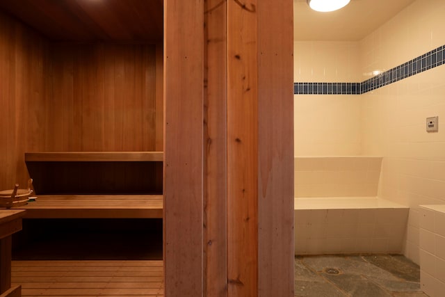 view of sauna featuring wooden walls