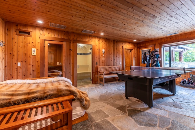 playroom with wooden walls and wood ceiling