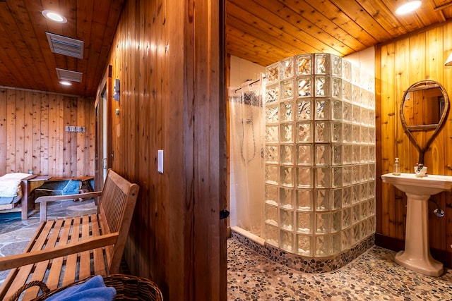 bathroom featuring wood ceiling, wooden walls, and walk in shower