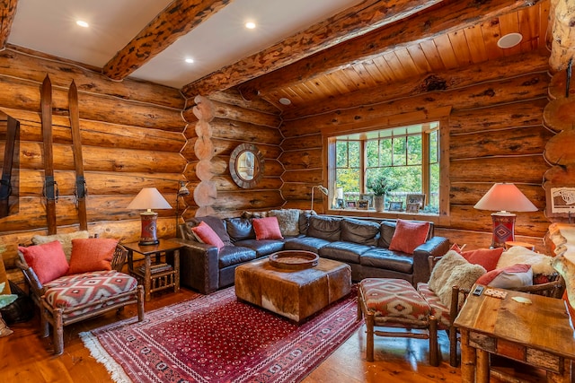 living room with beam ceiling, rustic walls, and hardwood / wood-style floors