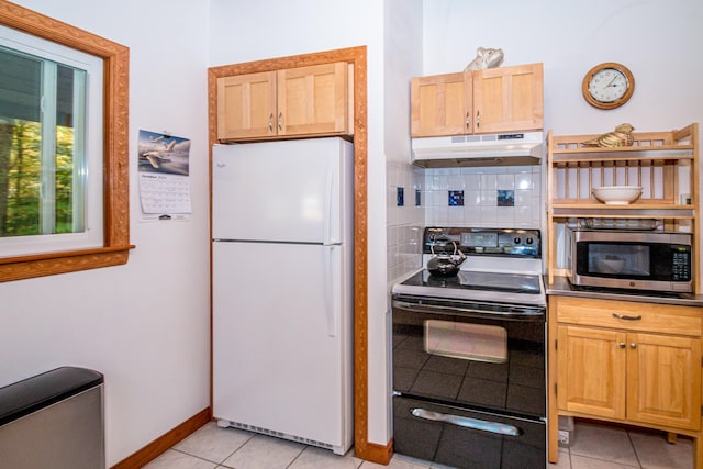 kitchen featuring white refrigerator, black range with electric cooktop, light tile patterned floors, and tasteful backsplash