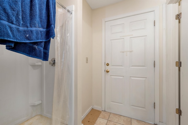 bathroom featuring walk in shower and tile patterned floors