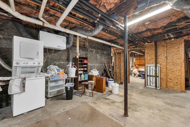 basement featuring stacked washer / dryer