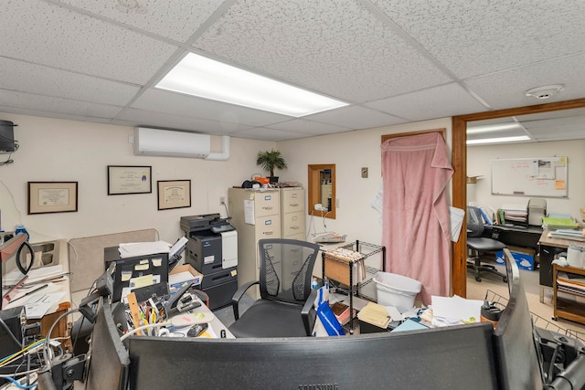 office space with a drop ceiling and an AC wall unit