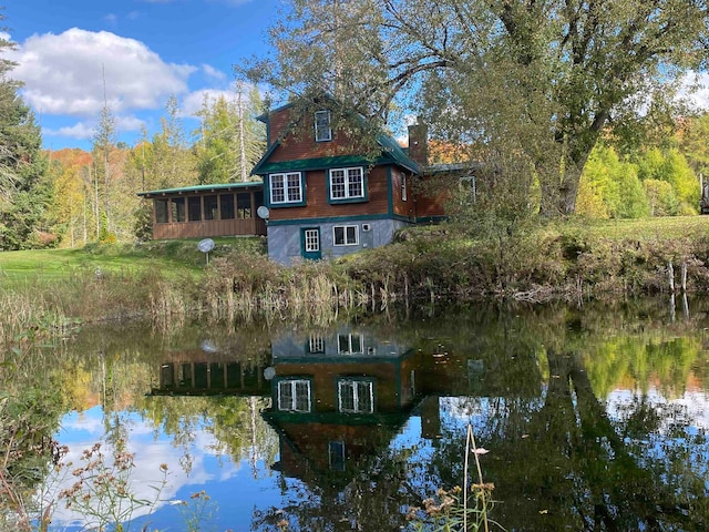 exterior space featuring a water view and a view of trees