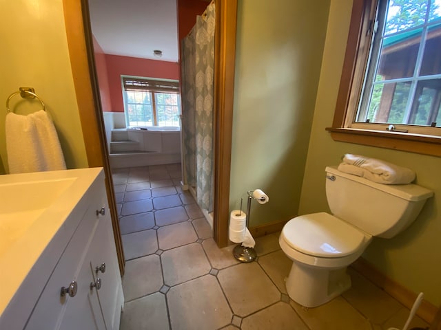 bathroom with toilet, tile patterned flooring, curtained shower, and baseboards