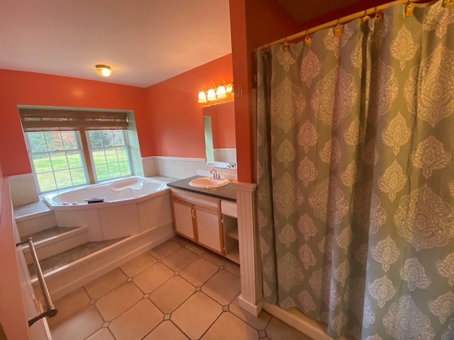 full bathroom with a shower with curtain, a garden tub, vanity, tile patterned flooring, and wainscoting