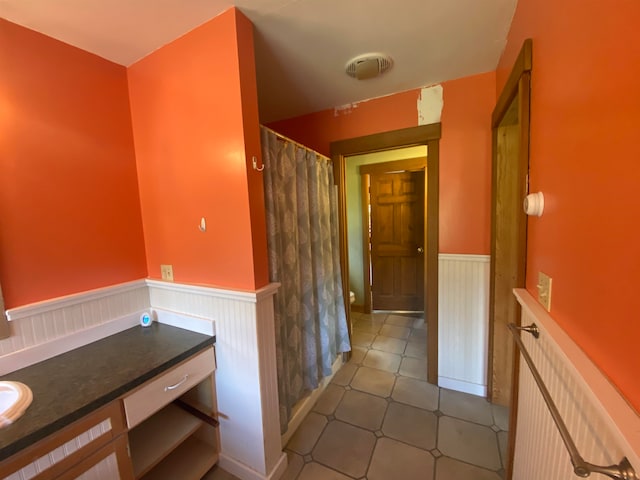 hallway featuring wainscoting
