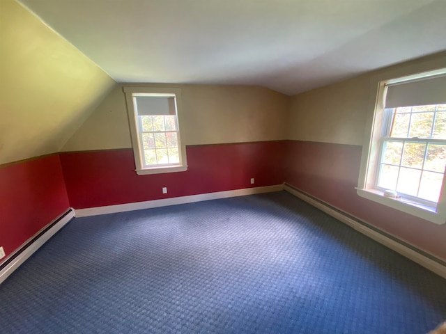additional living space featuring a baseboard radiator, carpet flooring, vaulted ceiling, and baseboards