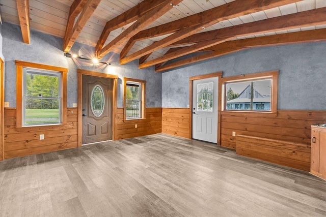 entryway with vaulted ceiling with beams, wooden walls, a wainscoted wall, wood ceiling, and wood finished floors
