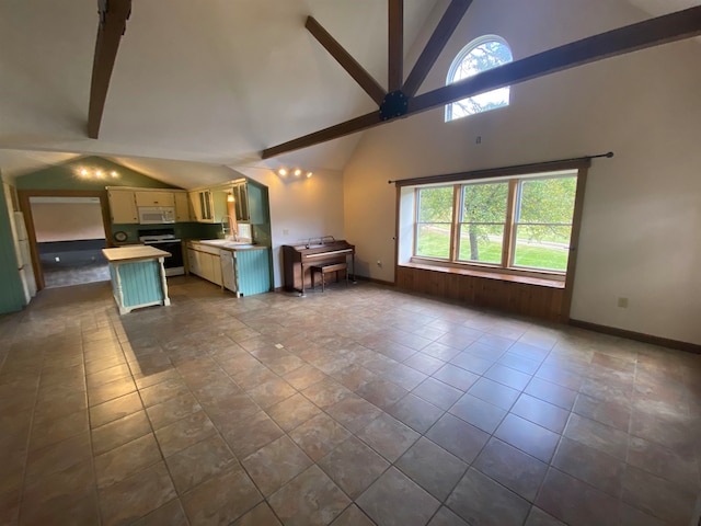 kitchen with beam ceiling, range with electric cooktop, high vaulted ceiling, ceiling fan, and white microwave
