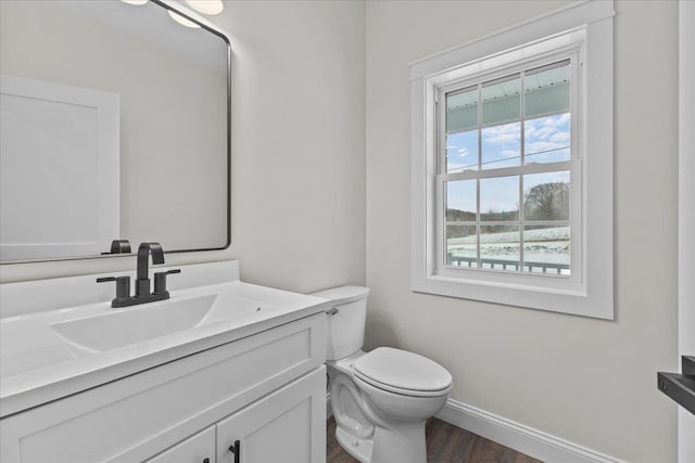 bathroom featuring hardwood / wood-style flooring, vanity, and toilet