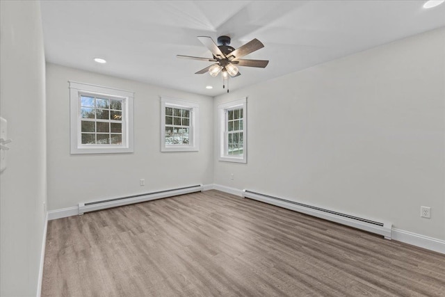 unfurnished room with baseboard heating, ceiling fan, and a healthy amount of sunlight