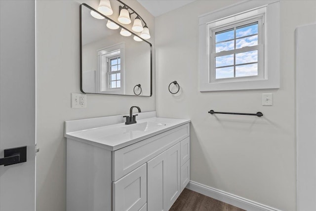 bathroom with hardwood / wood-style flooring, plenty of natural light, and vanity