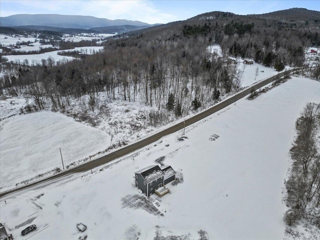 snowy aerial view with a mountain view