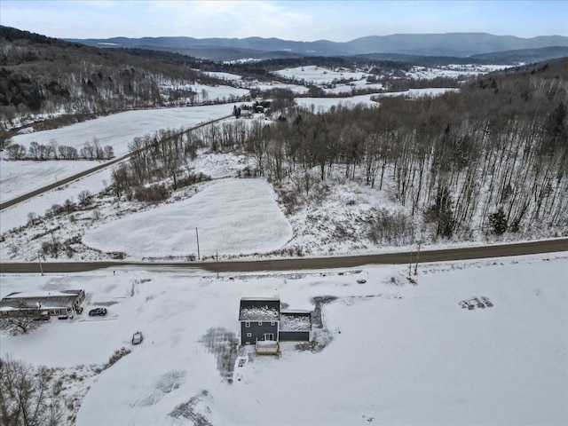 snowy aerial view featuring a mountain view