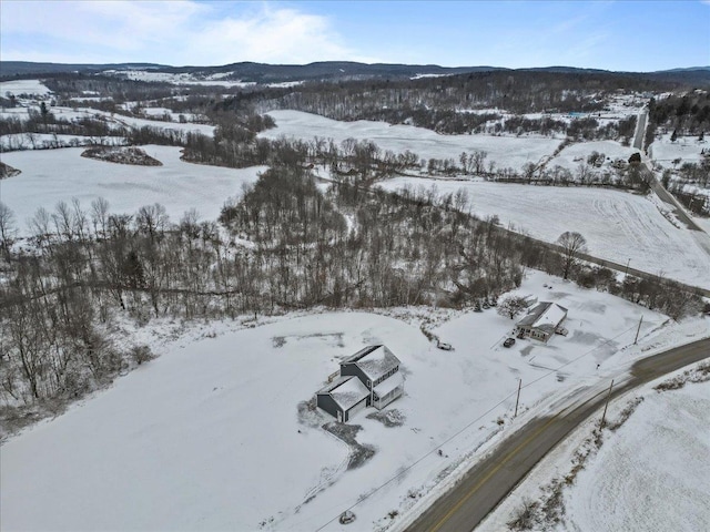 snowy aerial view with a mountain view