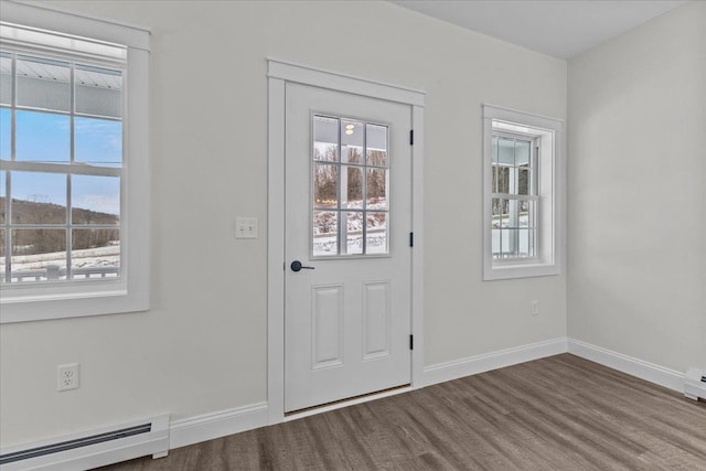 doorway with a healthy amount of sunlight and baseboard heating