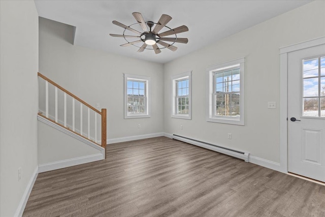 entryway featuring ceiling fan, light wood-type flooring, and a baseboard heating unit