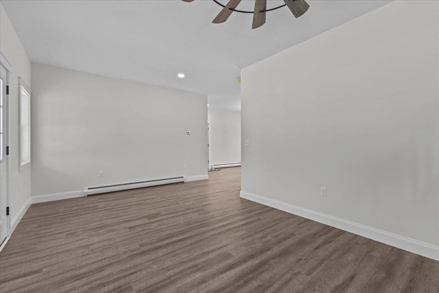 unfurnished room with baseboard heating, ceiling fan, and hardwood / wood-style flooring